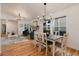 Bright dining room with hardwood floors, fireplace, and adjacent living area offers space for entertaining and Gathering meals at 8543 Redstone St, Highlands Ranch, CO 80126