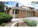 Two-story brick home with attached garage, manicured front yard, and well-maintained landscaping at 8543 Redstone St, Highlands Ranch, CO 80126