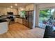 Bright kitchen features stainless steel appliances and an open floor plan with sliding glass door access to backyard at 8543 Redstone St, Highlands Ranch, CO 80126