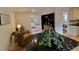 Inviting living room features wood floors, chairs, and entry to the updated kitchen at 8543 Redstone St, Highlands Ranch, CO 80126