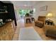 Bright living room features hardwood floors, and an open floor plan with great natural light, and sliding glass door access at 8543 Redstone St, Highlands Ranch, CO 80126