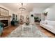 Bright living room featuring hardwood floors, a fireplace, modern furnishings, and an open floor plan at 8543 Redstone St, Highlands Ranch, CO 80126