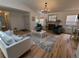 Bright living room features hardwood floors, a fireplace and an open floor plan with great natural light at 8543 Redstone St, Highlands Ranch, CO 80126