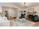 The living room has hardwood floors, a modern chandelier, a fireplace, and lots of natural light at 8543 Redstone St, Highlands Ranch, CO 80126