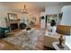 Bright living room features an open floor plan, hardwood floors, and a cozy fireplace at 8543 Redstone St, Highlands Ranch, CO 80126