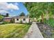 Backyard with lawn, small storage building, pathway and tree at 2411 N High St, Denver, CO 80205