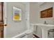 Bathroom featuring walk-in shower, pedestal sink and window for natural light at 2411 N High St, Denver, CO 80205