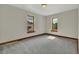 Empty bedroom featuring plush gray carpet, and windows with nice views at 2411 N High St, Denver, CO 80205