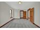 Bedroom with carpet, featuring wood trim and doors, and closet space at 2411 N High St, Denver, CO 80205
