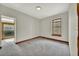 Bedroom featuring carpet, wood trim, neutral paint, and natural light at 2411 N High St, Denver, CO 80205