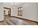Bright dining room features wood trim, modern light fixture and light, woodgrain-look flooring at 2411 N High St, Denver, CO 80205