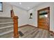 Cozy foyer featuring hardwood floors, staircase, and a charming front door at 2411 N High St, Denver, CO 80205