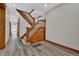 Elegant entryway with hardwood floors, a grand staircase, and intricate woodwork at 2411 N High St, Denver, CO 80205