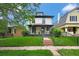 Charming two-story home featuring a welcoming front porch and well-maintained lawn at 2411 N High St, Denver, CO 80205