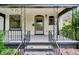 Inviting front porch featuring decorative ironwork and a classic entry door at 2411 N High St, Denver, CO 80205