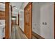 Hallway with light wood-look flooring and wood trim doors leads to laundry hookups at 2411 N High St, Denver, CO 80205