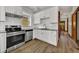 Updated kitchen features white cabinets, granite countertops, and stainless steel oven at 2411 N High St, Denver, CO 80205