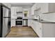 Modern kitchen featuring white cabinets, granite countertops, and stainless steel appliances at 2411 N High St, Denver, CO 80205