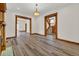 Spacious living room featuring hardwood floors, detailed trim, and open doorways at 2411 N High St, Denver, CO 80205