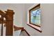 Staircase featuring a stained glass window and decorative wood banister at 2411 N High St, Denver, CO 80205