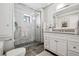 Bathroom features a glass shower, granite sink, and updated fixtures at 930 Acoma St # 108, Denver, CO 80204
