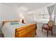 Bedroom with wooden bedframe, neutral walls, and access to the lofted area at 930 Acoma St # 108, Denver, CO 80204
