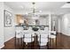 Elegant dining area with open layout to the kitchen and contemporary light fixture at 930 Acoma St # 108, Denver, CO 80204