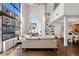 Bright living room with large windows, tall ceilings, hardwood floors, and built-in bookshelves filled with decor at 930 Acoma St # 108, Denver, CO 80204
