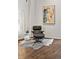 Living room features a modern chair, white side table, contemporary light fixture, and artwork at 930 Acoma St # 108, Denver, CO 80204