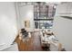 Open-concept living room featuring floor-to-ceiling windows, hardwood floors, and stylish furniture arrangement at 930 Acoma St # 108, Denver, CO 80204