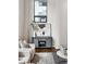 Comfortable living room showcasing a stylish console table with decor, a rug, hardwood floors, and natural light at 930 Acoma St # 108, Denver, CO 80204