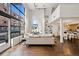 Spacious living room with tall ceilings, hardwood floors, and open floor plan at 930 Acoma St # 108, Denver, CO 80204