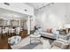 Open-concept living space with high ceilings, modern furniture, and abundant natural light at 930 Acoma St # 108, Denver, CO 80204