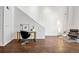 Open office space featuring a white desk, modern chair, hardwood floors, and contemporary lighting fixtures at 930 Acoma St # 108, Denver, CO 80204