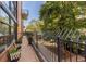 A walkway with bench seating and metal railing runs along a red brick building at 930 Acoma St # 108, Denver, CO 80204