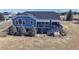 The back exterior offers a large deck with shade awning overlooking the backyard space at 14701 Yosemite St, Brighton, CO 80602
