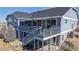 Home's deck with awning, steps to backyard, and outdoor living space create an inviting atmosphere at 14701 Yosemite St, Brighton, CO 80602