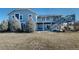 Backyard view of a two-story home featuring a multi-level deck and stairs in a serene outdoor setting at 14701 Yosemite St, Brighton, CO 80602