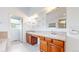 Bathroom with double vanity, tile counters, and a well-lit, inviting space at 14701 Yosemite St, Brighton, CO 80602