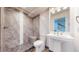Modern bathroom featuring tiled walk-in shower and pedestal sink at 14701 Yosemite St, Brighton, CO 80602