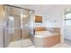 Bathroom featuring a glass shower, soaking tub, and tile surround at 14701 Yosemite St, Brighton, CO 80602