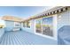 View of the deck featuring sliding glass doors that lead inside, an awning, and outdoor lighting at 14701 Yosemite St, Brighton, CO 80602