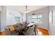 Elegant dining room features chandelier, table with six chairs, and window views at 14701 Yosemite St, Brighton, CO 80602