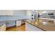 Bright, modern kitchen featuring stainless steel appliances, white cabinets, and a large center island at 14701 Yosemite St, Brighton, CO 80602