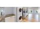 View of the stainless refrigerator and stacked laundry in the open concept living space at 14701 Yosemite St, Brighton, CO 80602