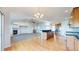 Open-concept kitchen and living area with hardwood floors, granite countertops and a cozy fireplace at 14701 Yosemite St, Brighton, CO 80602