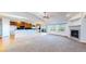Open floorplan living room and kitchen with hardwood floors, fireplace, and large windows at 14701 Yosemite St, Brighton, CO 80602