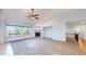 Bright living room with fireplace, ceiling fan, and view to the exterior at 14701 Yosemite St, Brighton, CO 80602