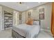 Neutral-toned bedroom featuring a gray platform bed frame, shelving unit, and modern decor at 5428 Forest View Rd, Parker, CO 80134