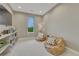 Bedroom featuring two large bean bag chairs, carpeted flooring, and a natural light window at 5428 Forest View Rd, Parker, CO 80134